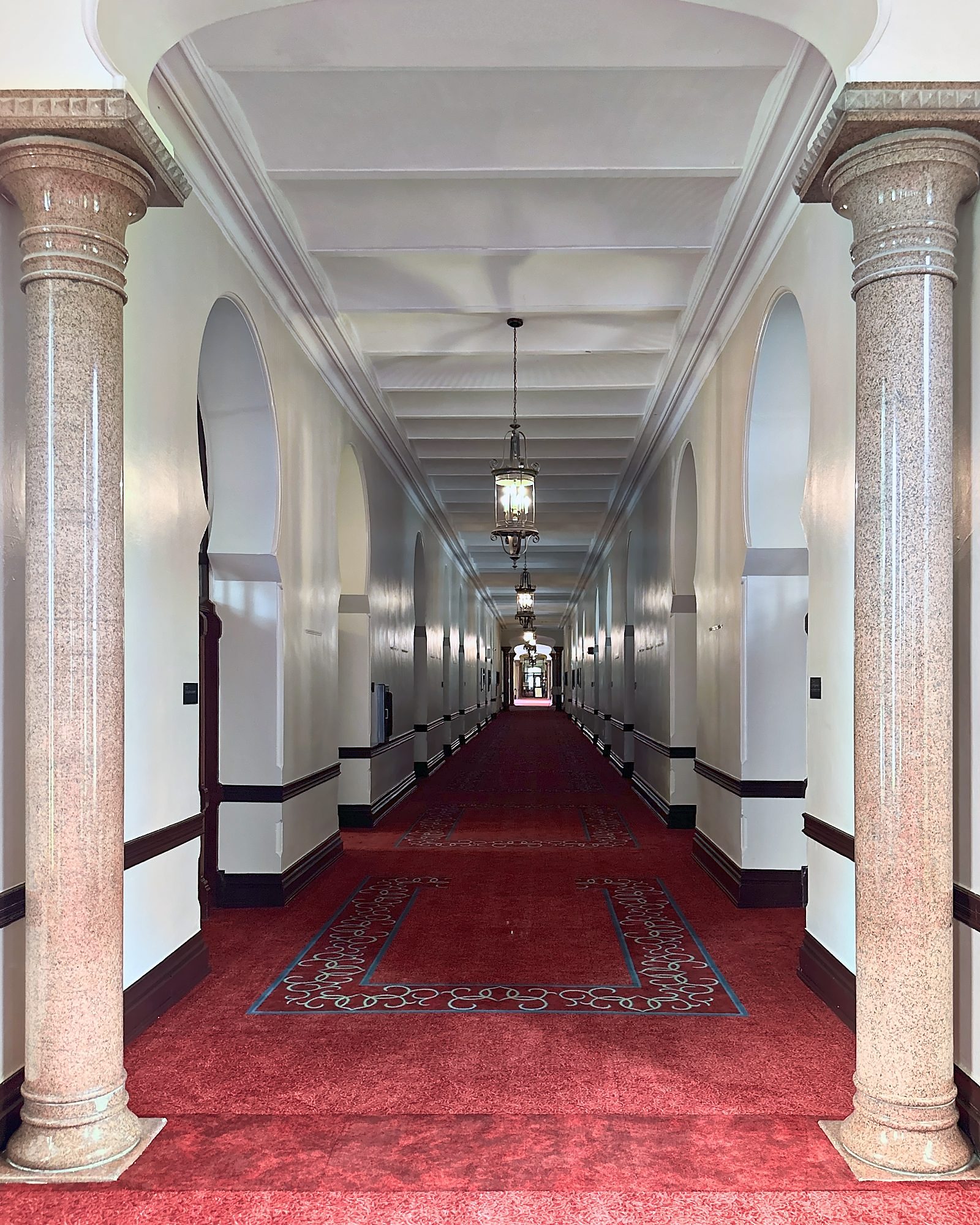 Restored historic columned corridor in a landmark university building, a renovation managed by Reno Boyd Building Co.